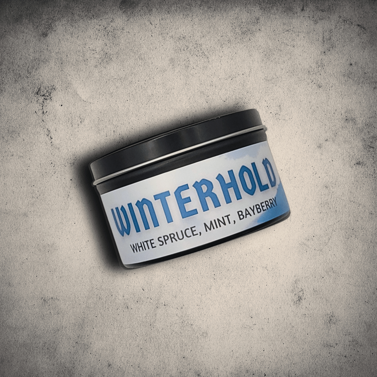 8oz candle tin labeled 'Winterhold' on a textured gray background